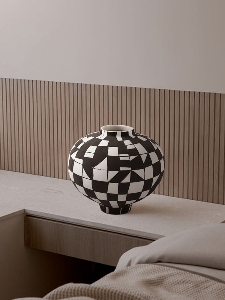 Black and white checkered ceramic vase on countertop, modern home decor